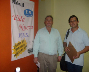 Fernando handing samples of the programs to the owner of a radio station in the Town of General Roca 